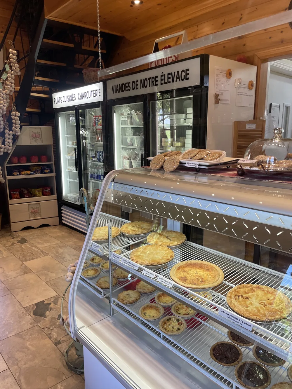 Farm-stand bakery counter with pies under glass